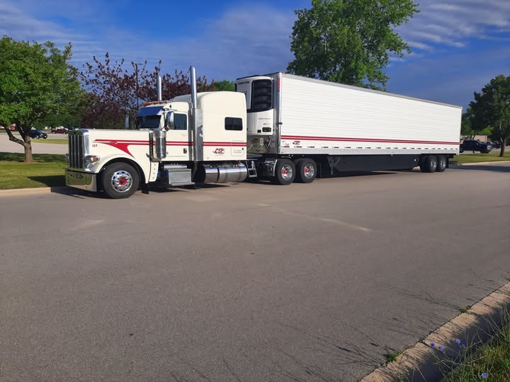 White classic long-hood tractor with refrigerated trailer